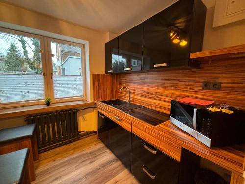 a kitchen with a microwave on a wooden counter at Hotel Mühlental in Wernigerode