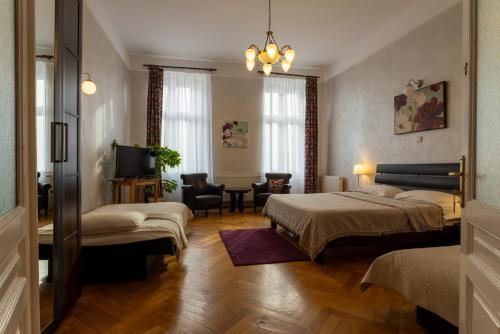 a hotel room with two beds and a television at Casa Balcescu in Braşov