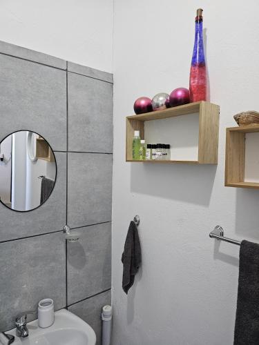 a bathroom with a mirror and a sink at Lalapanzi - Nxabba in Olifantshoek