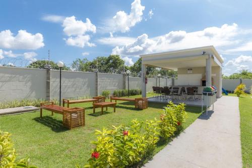 a backyard with benches and a gazebo at Apartamento próximo Aeroporto Cuiabá in Várzea Grande