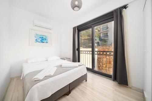 a bedroom with a bed and a large window at My house in Kaş in Kaş