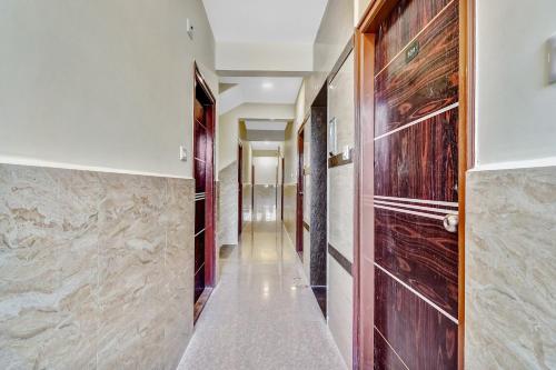 a hallway of a house with wood and marble walls at Super Hotel O Royal Suites in Bengaluru