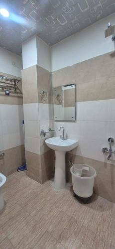 a bathroom with a sink and a toilet at Hotel inn de dogras in Udhampur