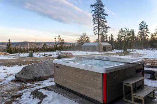 una vasca idromassaggio nella neve con una sedia di Luxury Chalet, Spacious, Jacuzzi & Sauna by Vacation Trysil a Trysil