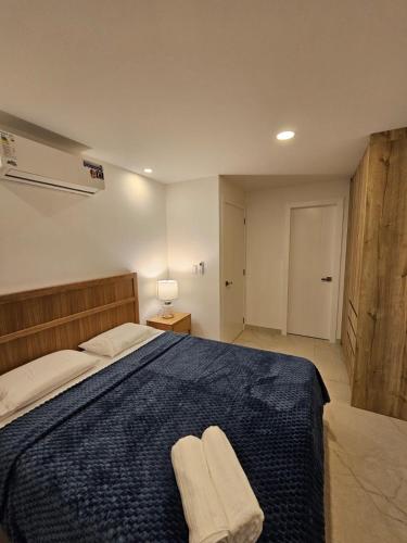 a bedroom with a bed with two towels on it at Beautiful Ocean View Apt Salinas Malecon Pier in Salinas