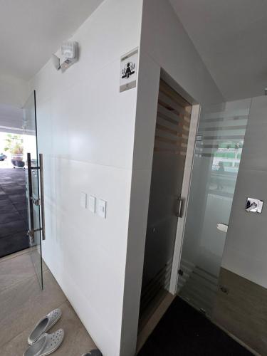 a hallway with a door to a room with shoes on the floor at Beautiful Ocean View Apt Salinas Malecon Pier in Salinas