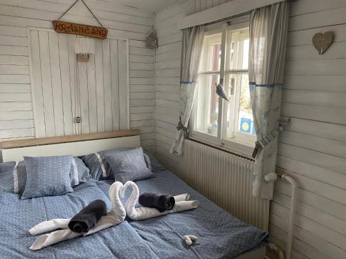 a bedroom with a bed with towels on it at Roubenka Doubravice in Hrubá Skála