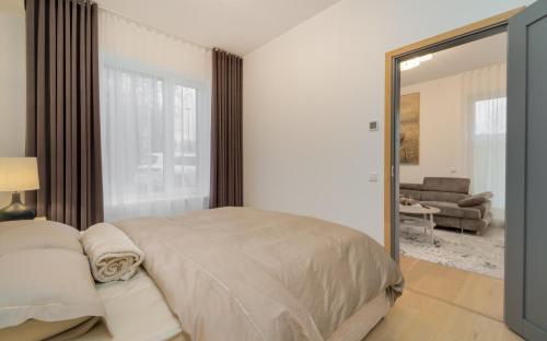a bedroom with a large bed and a mirror at Lodja Suites in Tartu