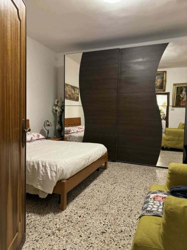 a bedroom with a bed and a large wooden cabinet at Ca' Malatin in Venice