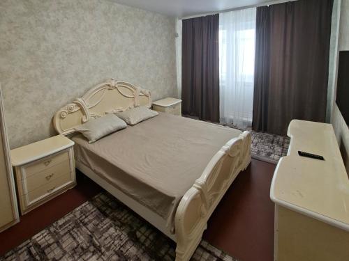 a bedroom with a white bed and a mirror at Cozy apartment in Kryvyi Rih