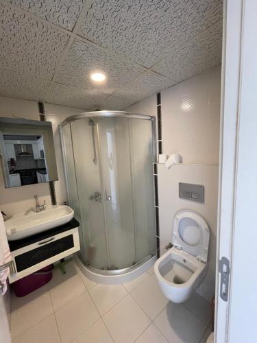 a bathroom with a shower and a toilet and a sink at Flat in Samsun atakum in Atakum