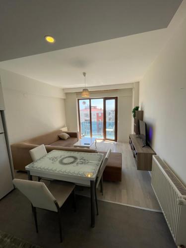 a living room with a table and a couch at Flat in Samsun atakum in Atakum