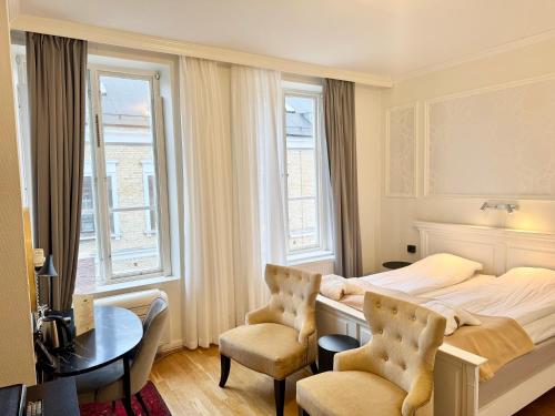 En eller flere senge i et værelse på Hotel Concordia