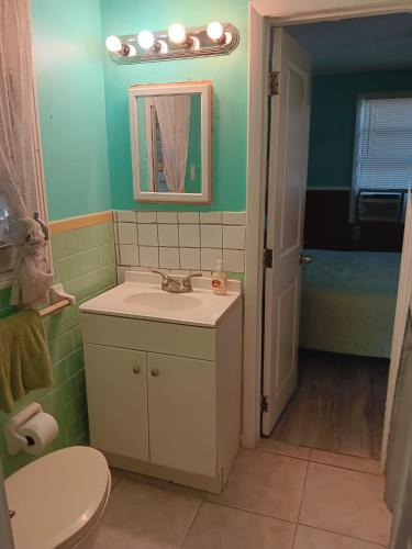 a bathroom with a sink and a toilet and a mirror at GpL 2668 one bedroom in Fort Myers