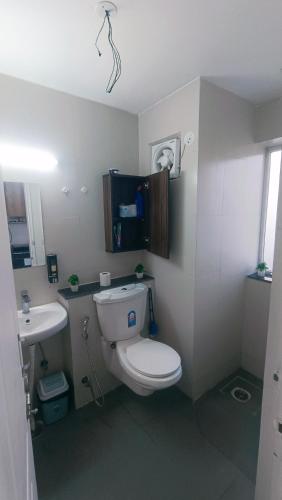 a bathroom with a toilet and a sink at NXone STUDIO APARTMENT in Noida