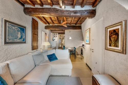 a living room with a white couch and a table at Marina Vista Apartment in Riomaggiore
