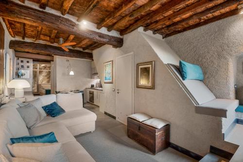 a living room with a white couch and stairs at Marina Vista Apartment in Riomaggiore