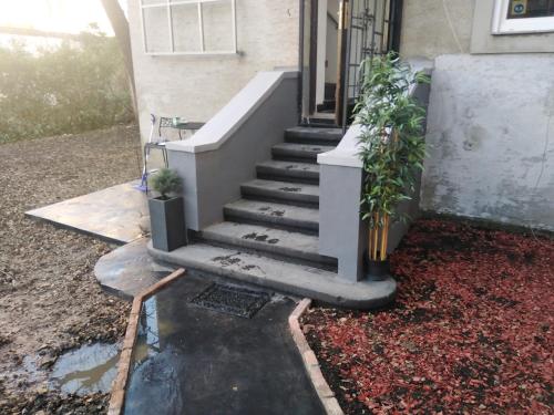 un escalier menant à une maison ornée de plantes dans l'établissement HEBRANGOVA Apartman, à Drljanovac