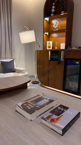 a living room with two books on the floor at مارڤت للإيجار اليومي in Hafr Al-Batin