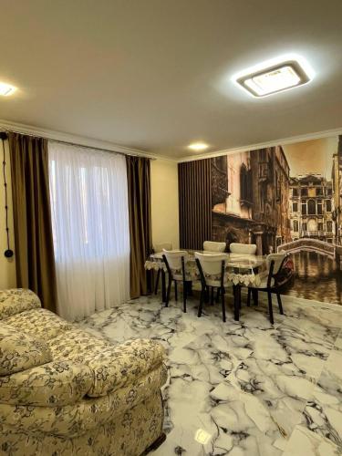 a hotel room with a bed and a table and chairs at Дома в Дилижане in Dilijan