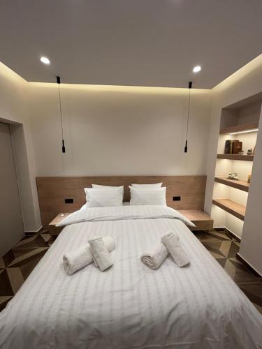 a bedroom with a bed with two slippers on it at The Cozy Residence in Veria
