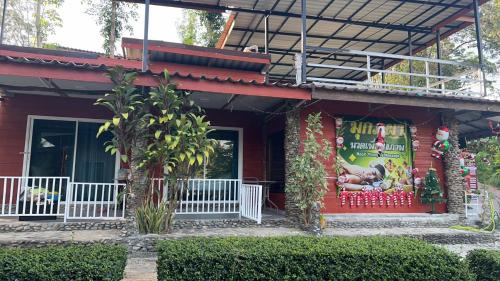 a house with a christmas sign on the side of it at Mook Phoopha Guest House in Koh Mook