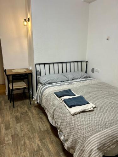 a bed with two towels on it in a room at Cozy and Tiny Nest in Gudauri in Gudauri