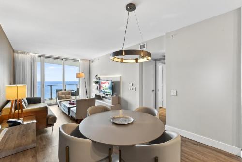 a living room with a table and chairs at Splendid Resort - Oceanview 1BDR & 1BA Apt Right on the Beach, Heated pool, GYM in Hollywood