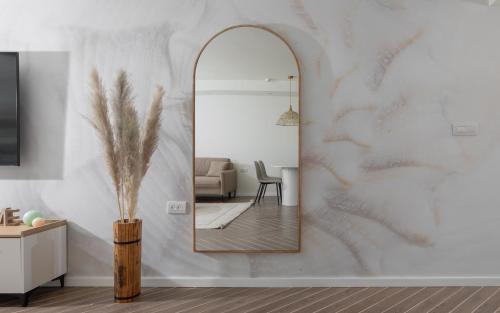 a mirror on a wall in a living room at סי סייד - אביה סונסטה in Eilat
