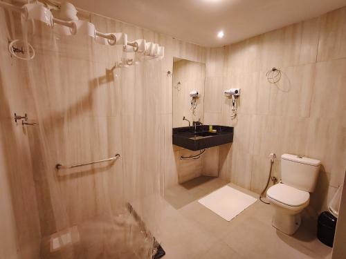 a bathroom with a toilet and a shower and a sink at Amazon Seasons hotel in Belém