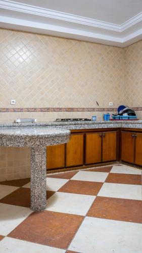 a kitchen with a granite counter top in a room at Villa de luxe vue sur mer in Moulay Bousselham