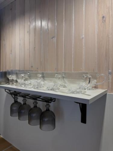 a row of glass bowls on a shelf at Гори і тиша gory & tysha in Yavoriv
