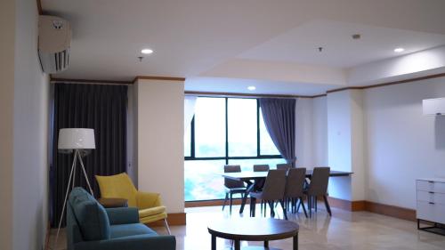 a living room with a table and chairs at Khodijah Homestay in Medan