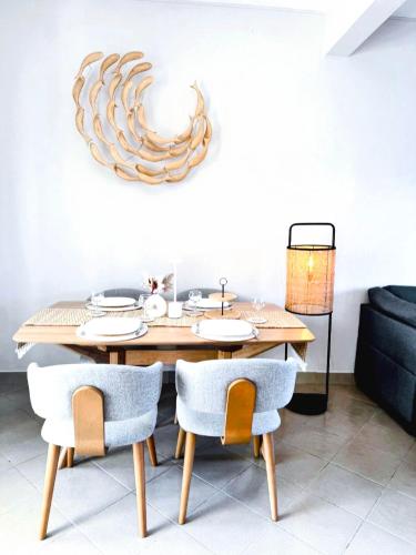 a dining room with a wooden table and chairs at Zephyr House 3BR Pool, Rooftop & Ocean View in Grande Gaube