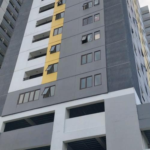 a tall building with many windows in a city at Khodijah Homestay in Medan