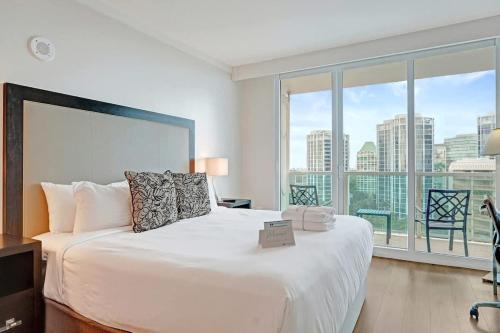 a bedroom with a large white bed with a large window at Studio with Bay and City View at The Arya in Miami