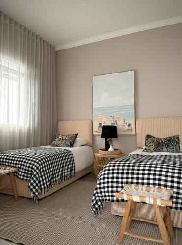 a bedroom with two beds and a window at Palm Springs in Struisbaai