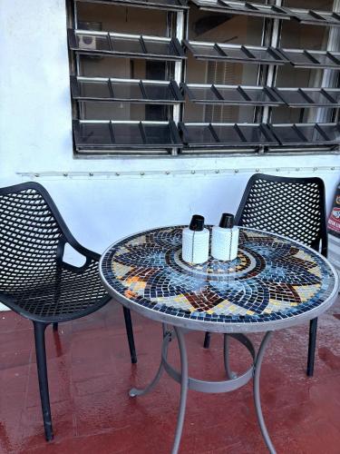 a table with two chairs and two cups on it at Come Chill on the Hill in Nazareth