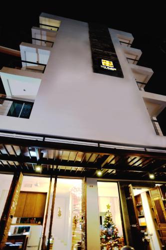 a building with a christmas tree in front of it at The Album Hotel in Patong Beach