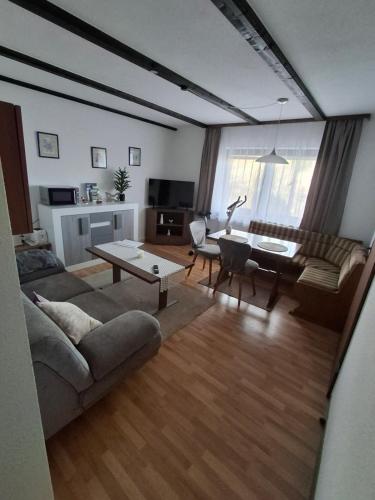 een woonkamer met een bank en een tafel bij Ferienwohnung Natalia in Thalfang