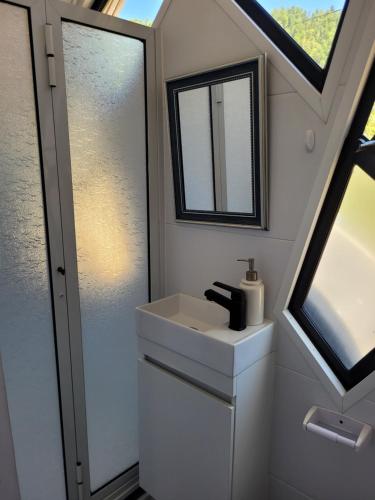 a bathroom with a sink and a mirror at Achibueno Glamping in Linares