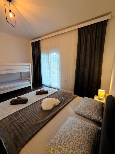 a bedroom with two beds with towels on them at Apartman Fratelli in Ljubuški