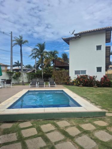 a swimming pool in the yard of a house at Buzios Inn in Búzios