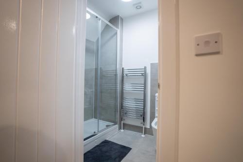 a bathroom with a glass shower with a toilet at Seamflow Homes - Folkestone, near Eurotunnel - Channel Tunnel in Folkestone