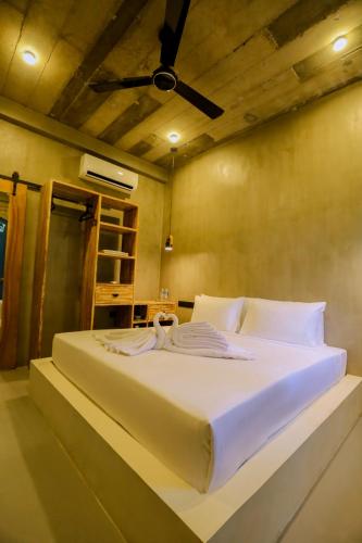 a bedroom with a large bed with towels on it at Arcadian Weligama in Weligama