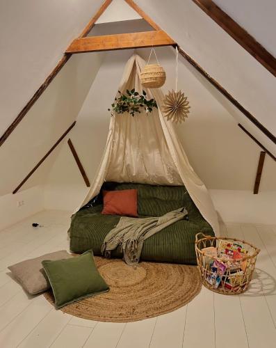 a living room with a couch in a tent at Het Witte Huisje in Ezinge