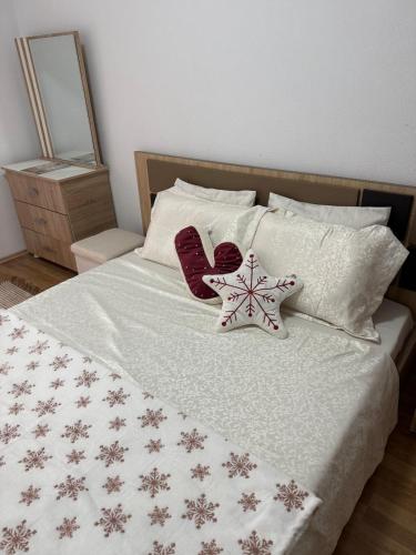 un letto con due decorazioni natalizie sopra di 01 Apartment a Kosovo Polje