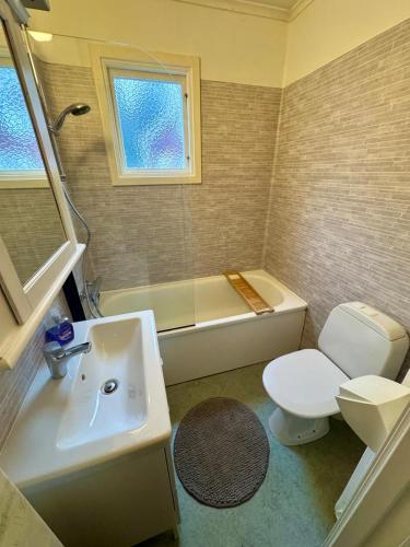 a bathroom with a sink and a toilet and a tub at House near forest and water in Hagfors