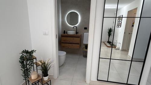 a bathroom with a toilet and a mirror at Palmview Private Pool in Arguineguín