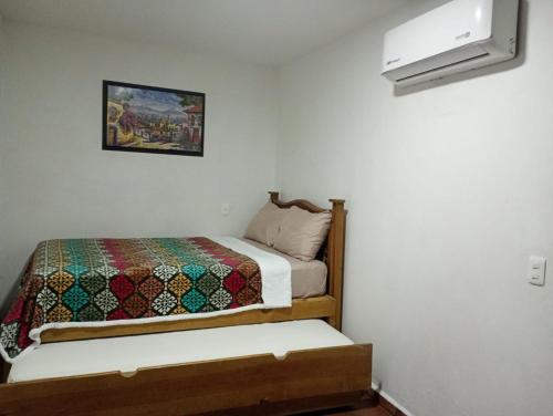 a bedroom with a bed with a quilt on it at Hotel Boutique Casa Elefante in Guadalajara